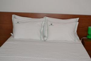 Uma cama ou camas num quarto em Hotel Comércio