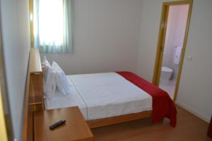 Uma cama ou camas num quarto em Hotel Comércio