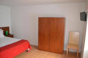 Uma cama ou camas num quarto em Hotel Comércio