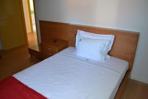 Uma cama ou camas num quarto em Hotel Comércio