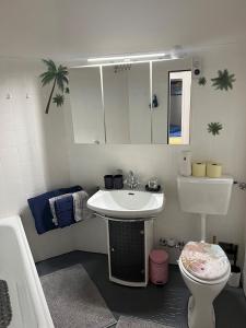 a bathroom with a sink and a toilet at living Appartement in Flachau