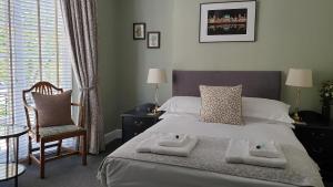 a bedroom with a bed with two towels on it at Starlings Guest House in Brighton & Hove