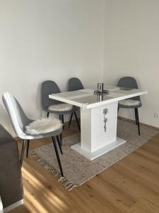 a white table and chairs in a room at living Appartement in Flachau