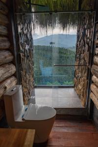 a bathroom with a bath tub and a large window at Eco Hotel Glamping El Silencio in Santa Rosa de Cabal