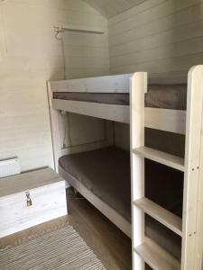 a small room with two bunk beds in it at Hailuoto Marjaniemi - Rantasumppu Cottage 2 - With Sauna - Close to the beach in Hailuoto