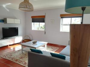 a living room with a couch and a table at Camarção Violante in Foz do Arelho