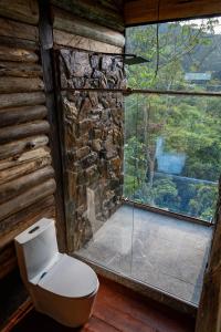 a bathroom with a toilet in front of a window at Eco Hotel Glamping El Silencio in Santa Rosa de Cabal