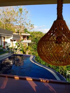 a hammock is hanging over a swimming pool at Bagus Ink Surf Camp in Uluwatu
