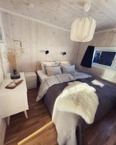 a bedroom with a large bed and a table at Skarvebo - cabin with amazing view in Myro