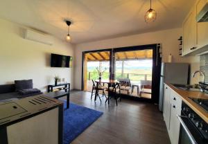 a kitchen and living room with a table and chairs at Evergreen house Plitvice in Rakovica