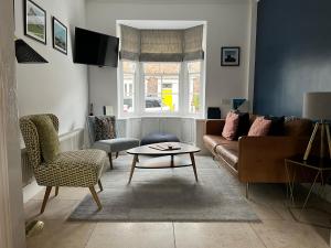 a living room with a couch and a table at Best Stays York - Alma York in York