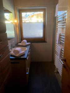 a bathroom with a sink and a window at Mountain Apart Katzenkopf in Leutasch +22 photos