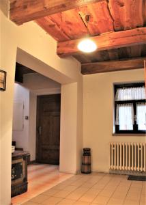 a room with a wooden ceiling and a door at Vila Líška in Pavčina Lehota