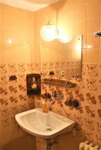 a bathroom with a sink and a mirror at Vila Líška in Pavčina Lehota