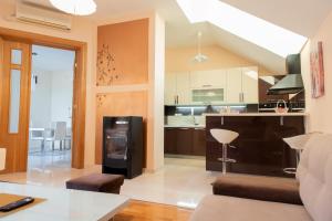 a kitchen and living room with a couch and a table at Secret View Apartment in Mostar
