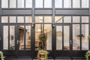 a black building with large glass windows at La Martinoise Patio in Saint-Martin-de-Ré