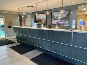 a lobby with a blue counter with flowers on it at Super 8 by Wyndham Edmonton South in Edmonton