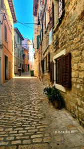 an empty cobblestone street in an old building at All My Loving in Rovinj