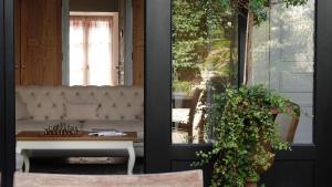 a porch with a couch and a table and a window at La Martinoise Patio in Saint-Martin-de-Ré