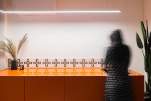 a shadow of a person standing next to a counter at Etern Stays - Boutique Apartment in Pristina