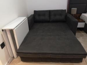 a couch in a living room with a bed at Zoned II Kopaonik - Studio Njegomir in Kopaonik