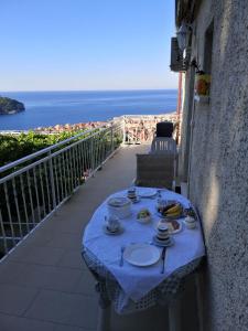 a table with plates of food on a balcony at Guest House Blaise in Dubrovnik