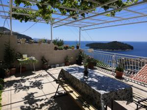 a table on a patio with a view of the ocean at Guest House Blaise in Dubrovnik