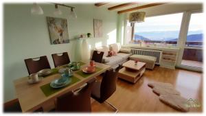 a living room with a table and a couch at Apartment THE VIEW in Zirkitz