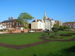 a park with benches and buildings in a city at Old Lighthouse View penthouse in Harwich