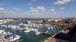 a marina filled with lots of boats in the water at Apartamentos Solmares in Isla Canela