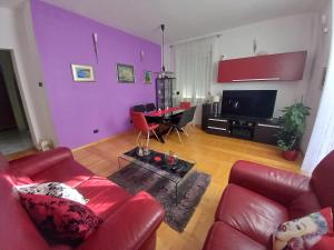 a living room with a red couch and a table at Apartman Diana in Split