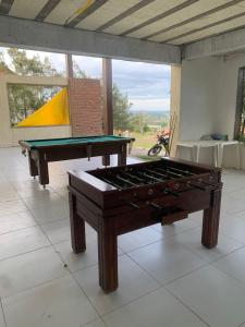 a pool table sitting on a tile floor in a room at Monte Castelo Gravatá in Gravatá