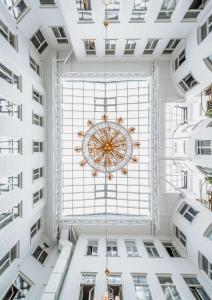 a large chandelier hangs from the ceiling of a building at Best Western Hotel Bentleys in Stockholm