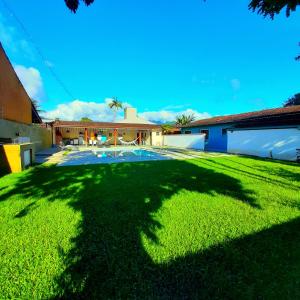a large yard with a large shadow of a tree at Recanto Isla Pousada in Ubatuba
