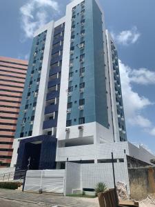 a tall building with a fence in front of it at Apartamento Manaíra pertinho do Mar in João Pessoa