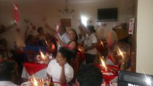 a group of people standing in a room with candles at Residencial Vitoria in Ponta do Sol