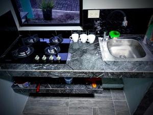 a kitchen counter top with a sink and a sink at Casa Scalesia Apartments Galápagos in Puerto Baquerizo Moreno