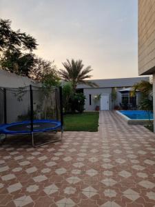 a patio with a swing in front of a building at Valley Villa in Jeddah