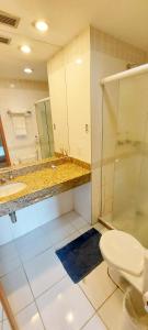 a bathroom with a toilet and a sink and a shower at Tropical Executive Flat Vista Maravilhosa do Rio in Manaus