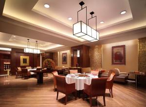 a restaurant with tables and chairs in a room at New Coast Hotel Manila in Manila