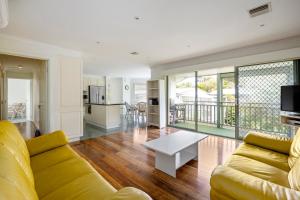 a living room with a couch and a table at Sand and Foam in Sorrento