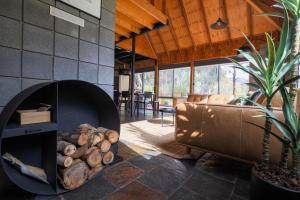 a living room with a fire pit in a house at Grampians Getaway in Halls Gap