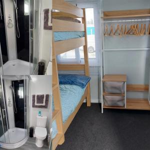 a small room with a bunk bed and a bathroom at Self Contained 2BR holiday unit in Richmond Tasman in Richmond