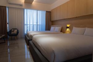 En eller flere senge i et værelse på 台南安平包棟民宿 - 定言豪宅館