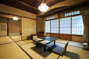 
a room with a couch, chair, table and a window at Fukuzumiro in Hakone
