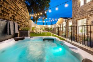 a hot tub on the patio of a house at Lower Arthur's Cottage in Saddleworth, Manchester in Oldham