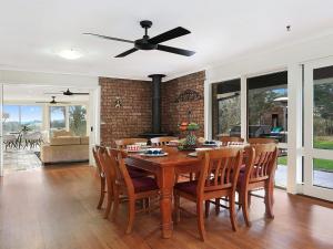 a dining room with a table and chairs at Cooinda in Kangaloon +14 photos