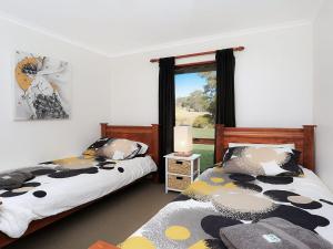 a bedroom with two beds and a window at Cooinda in Kangaloon