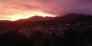 a view of a city at sunset at Wind Valley Farmstay in Kundasang