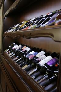 a wine rack with lots of bottles of wine at Villa Augusto Boutique Hotel & SPA in Konaklı